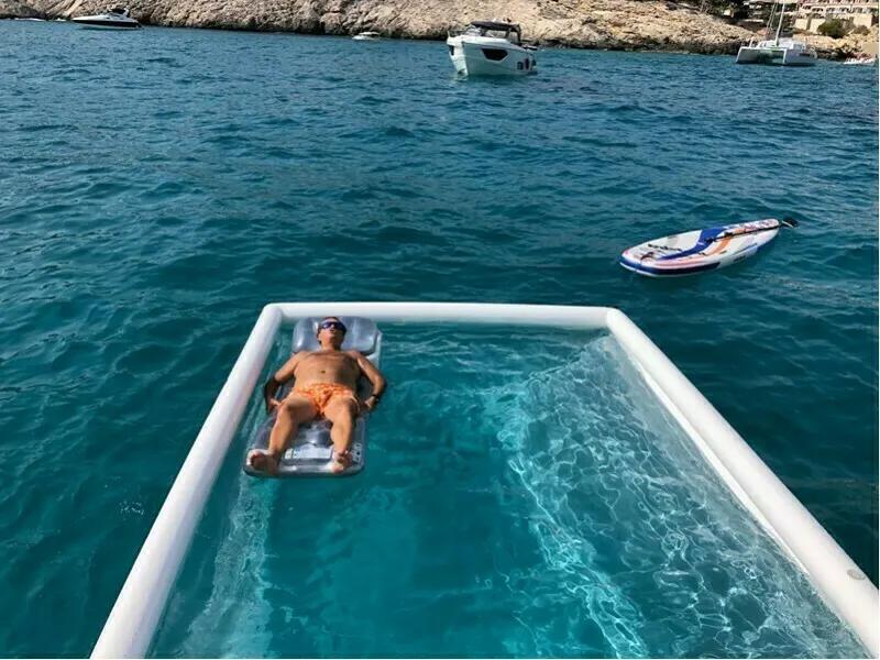 Man floating in inflatable sea pool in Mallorca